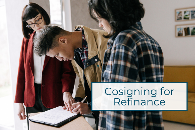 Refi Cosigner three people stand over a desk while a young man in the middle signs paperwork