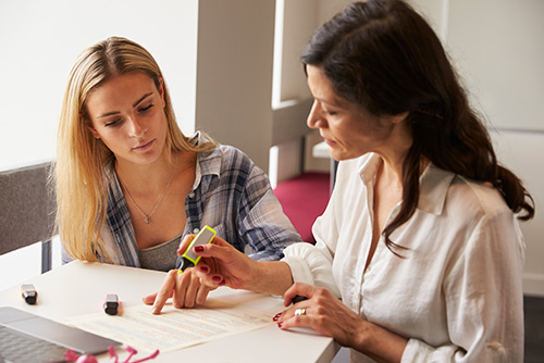 june-college-funding-2025 Mother and daughter reviewing college funding documents in June 2025